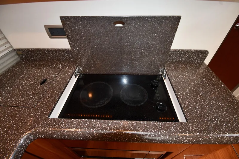  Yacht Photos Pics 2007 Formula 45 Yacht kitchen with sleek black cooktop and speckled countertop.