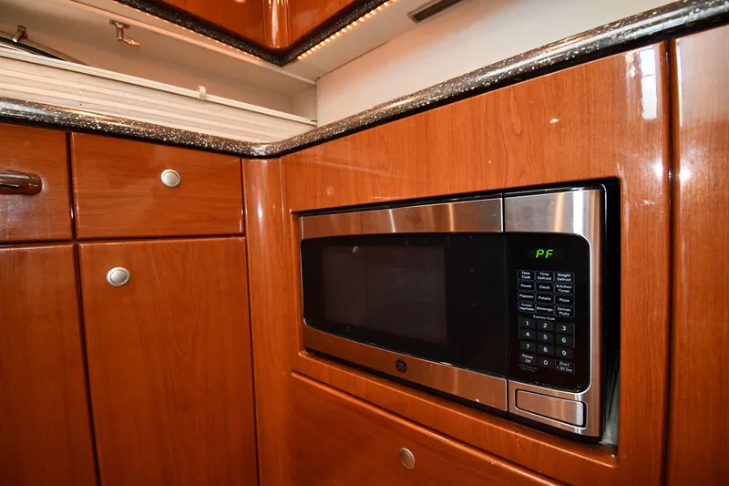  Yacht Photos Pics Luxury yacht kitchen with wood cabinetry and built-in microwave, Formula 45 Yacht 2007.