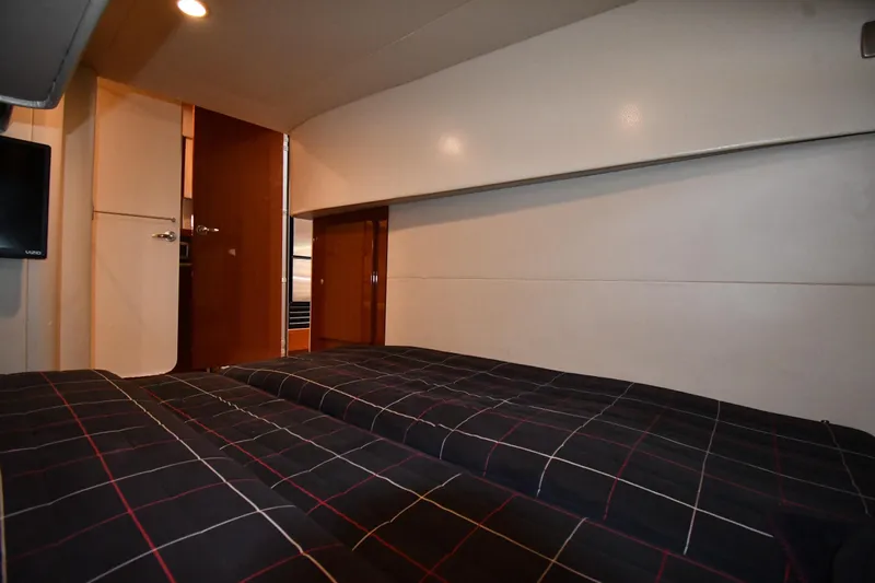  Yacht Photos Pics Interior cabin of 2007 Formula 45 Yacht with plaid bedding and modern design.