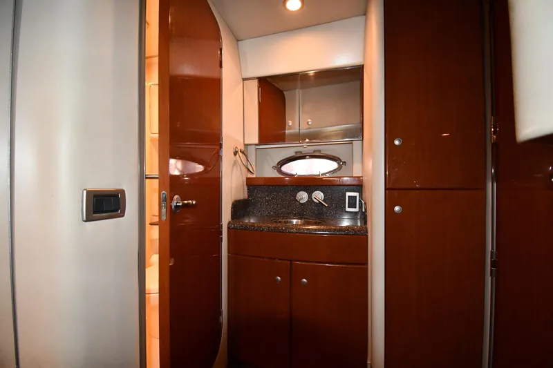  Yacht Photos Pics 2007 Formula 45 Yacht interior with wooden cabinetry and compact bathroom.