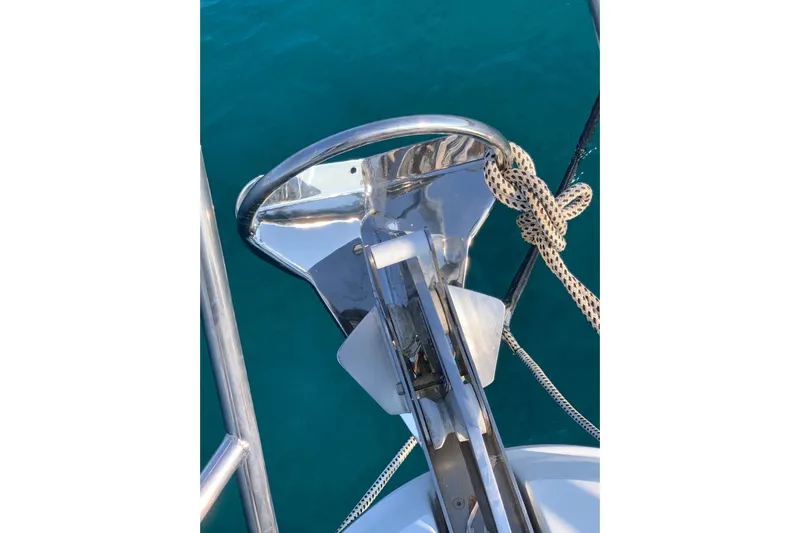  Yacht Photos Pics Bow anchor of 2012 Beneteau Gran Turismo 44 yacht with rope, over blue water.