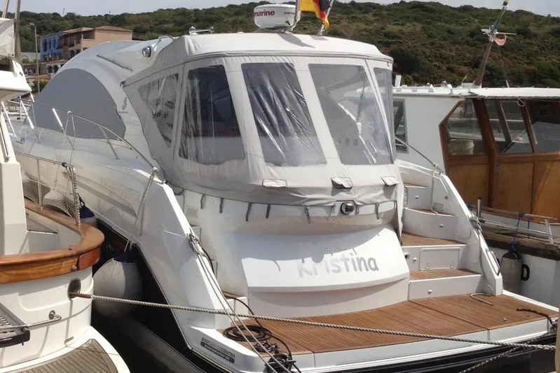  Yacht Photos Pics 2012 Beneteau Gran Turismo 44 yacht docked, featuring sleek design and covered cockpit.