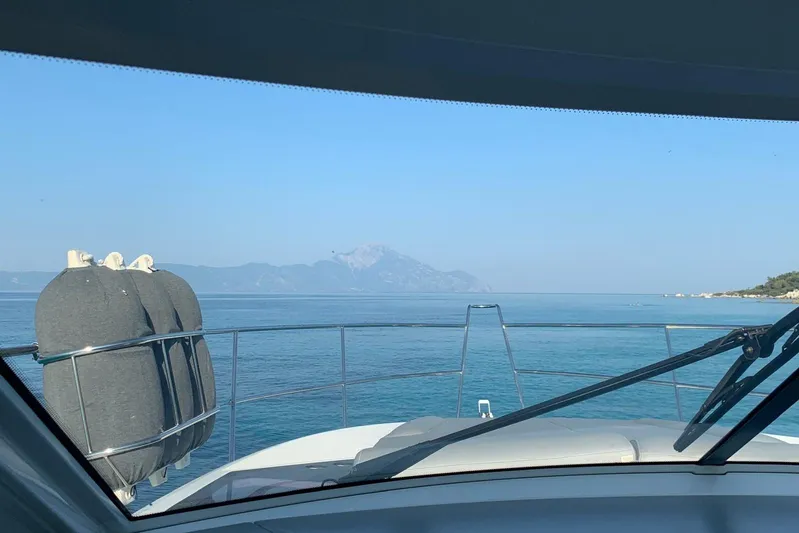  Yacht Photos Pics View from 2012 Beneteau Gran Turismo 44 yacht, overlooking serene blue sea and distant mountains.