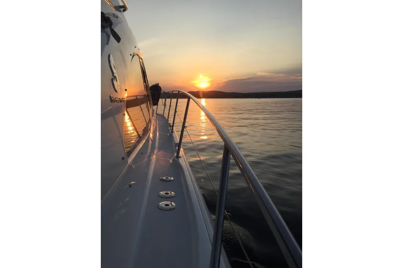  Yacht Photos Pics 2012 Beneteau Gran Turismo 44 yacht at sunset on calm waters.