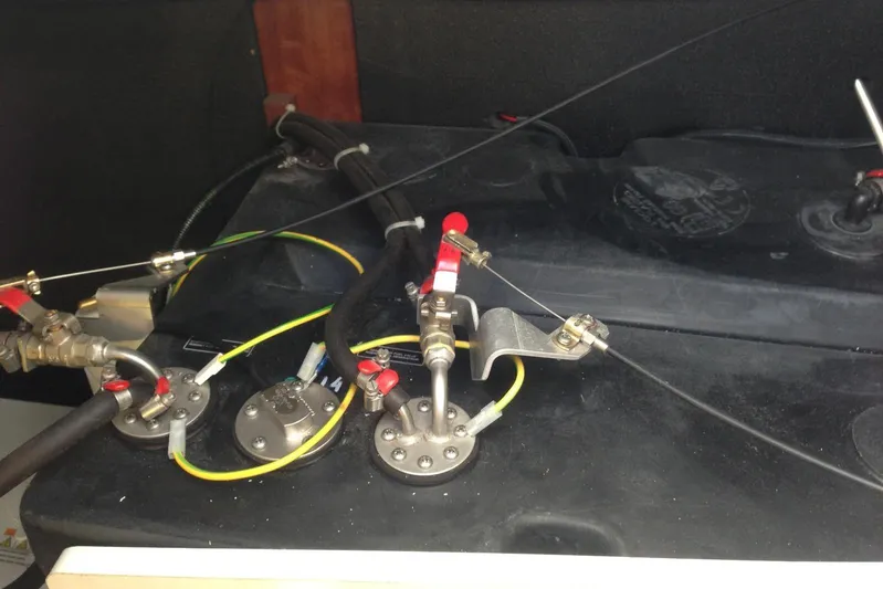  Yacht Photos Pics Engine compartment of a 2012 Beneteau Gran Turismo 44 with visible fuel lines and connectors.