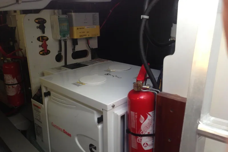  Yacht Photos Pics Engine room of 2012 Beneteau Gran Turismo 44 with fire extinguisher and generator.