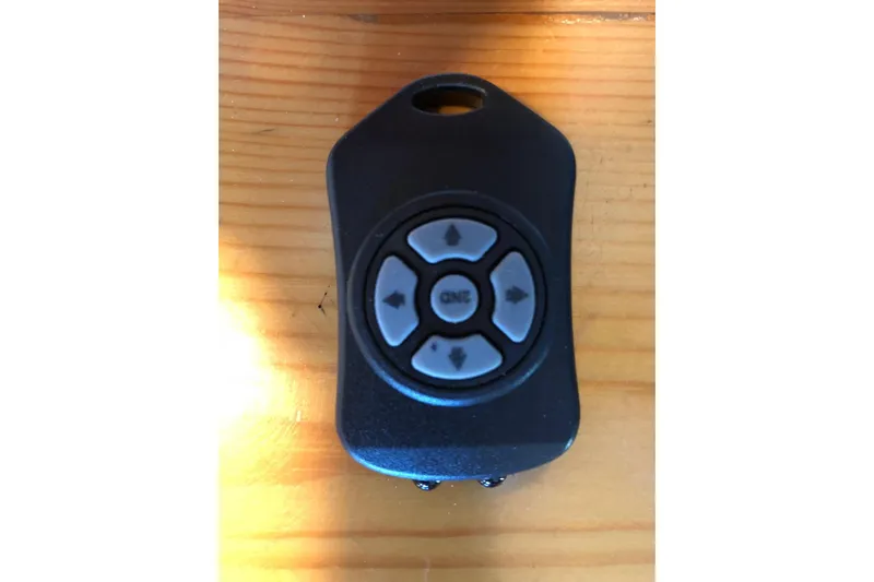  Yacht Photos Pics Remote control for 2012 Beneteau Gran Turismo 44 on wooden surface.