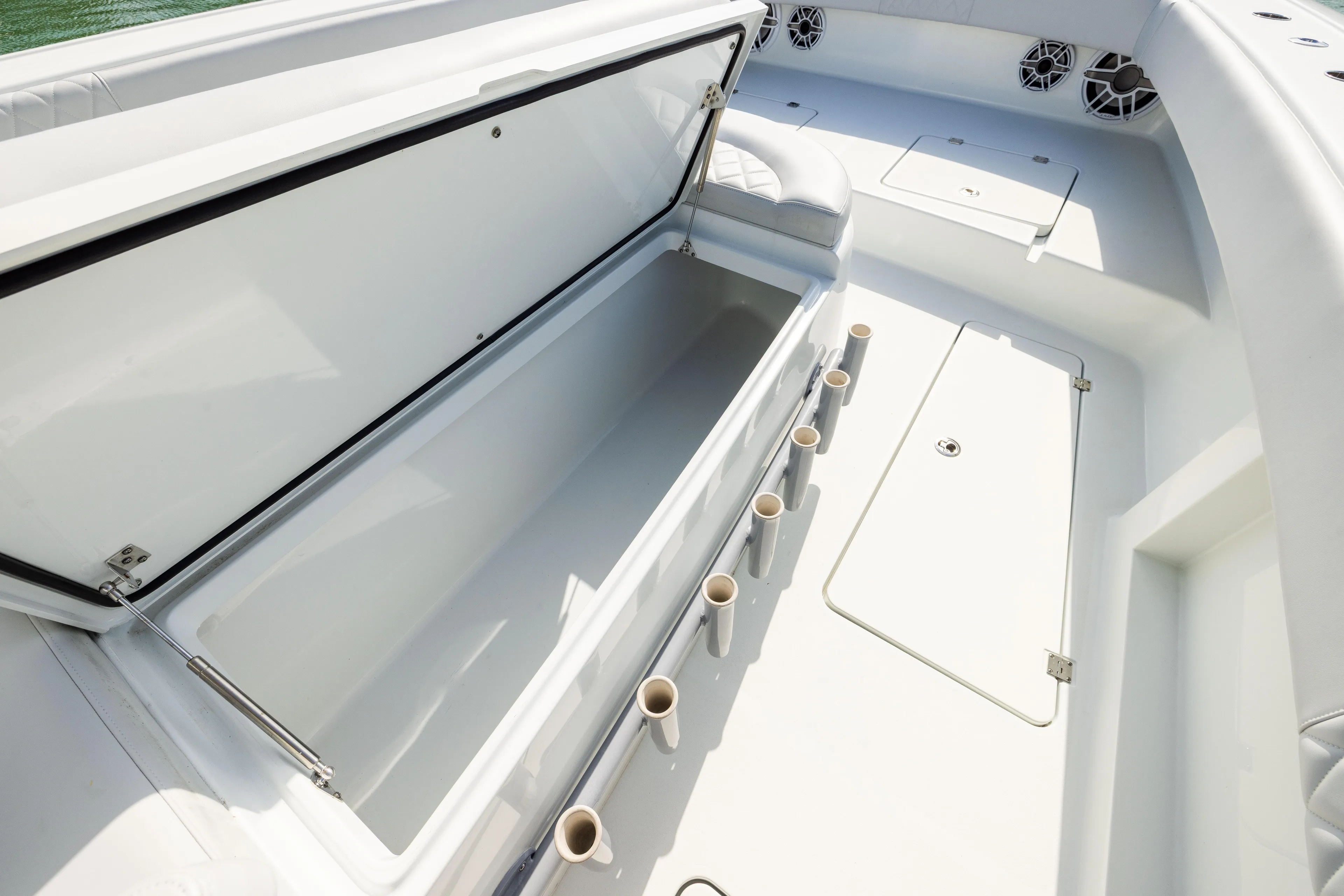  Yacht Photos Pics Open storage compartment on 2022 Freeman 42LR boat deck with rod holders.