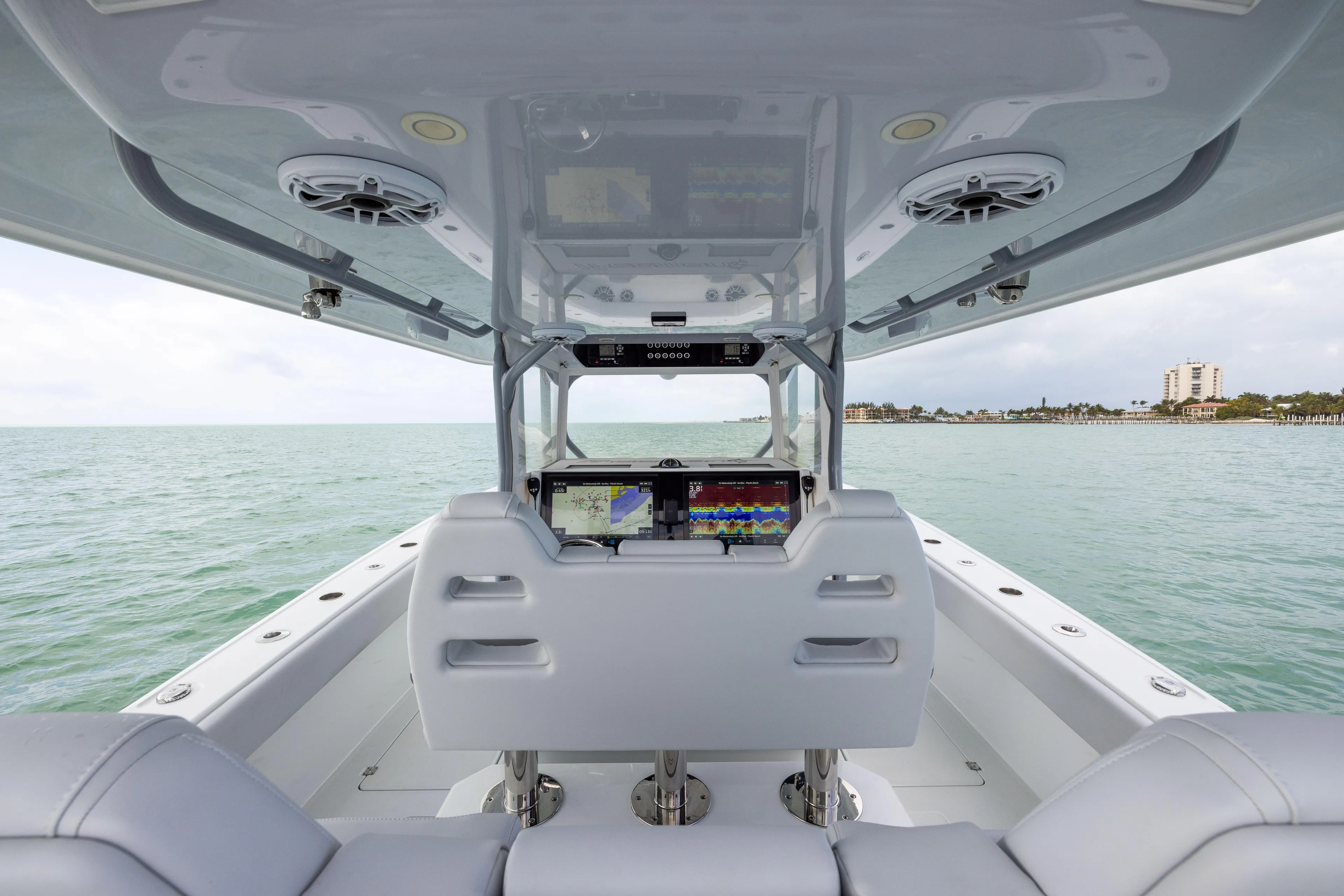  Yacht Photos Pics Interior view of 2022 Freeman 42LR boat with advanced navigation screens on open water.