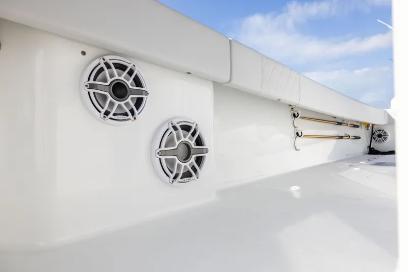  Yacht Photos Pics 2022 Freeman 42LR boat interior with speakers and rod holders, showcasing sleek design.