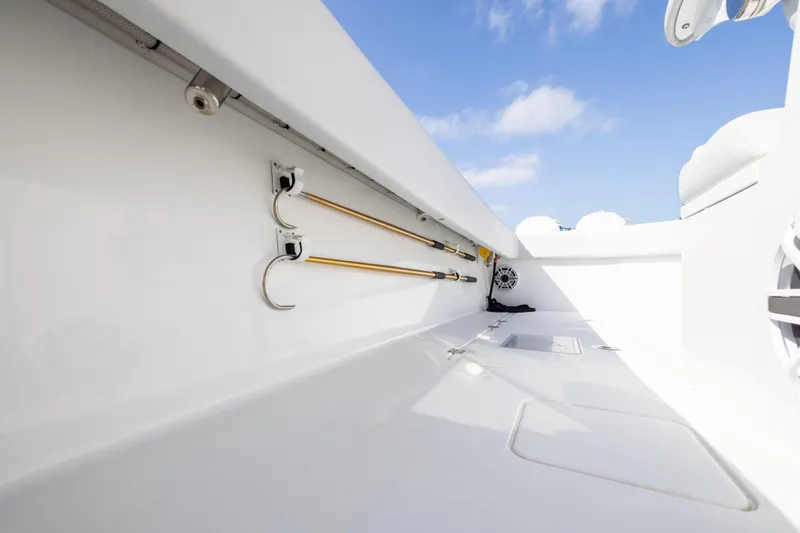  Yacht Photos Pics Interior view of 2022 Freeman 42LR boat with fishing rod holders and storage.