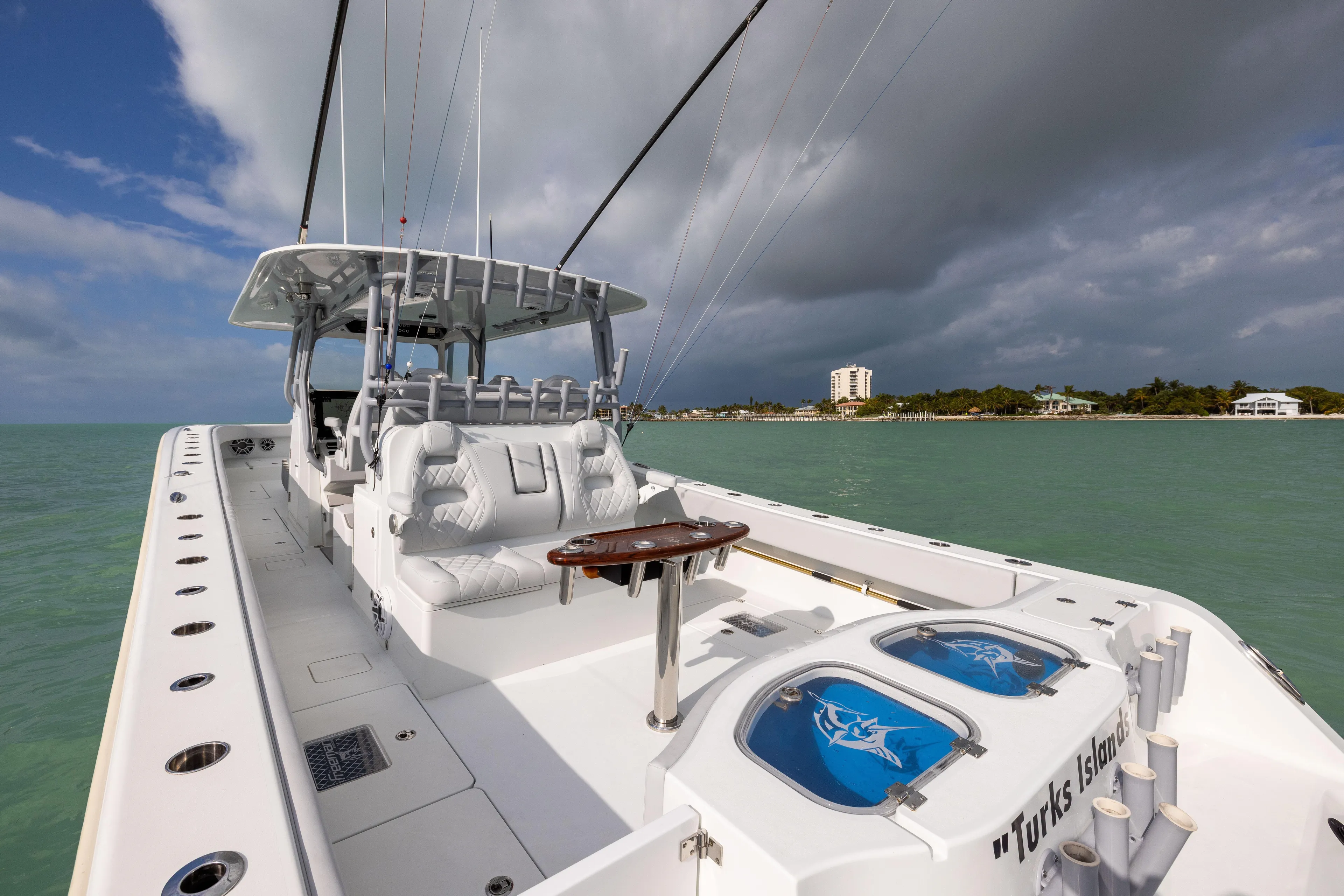  Yacht Photos Pics 2022 Freeman 42LR boat on turquoise waters near a coastal island.