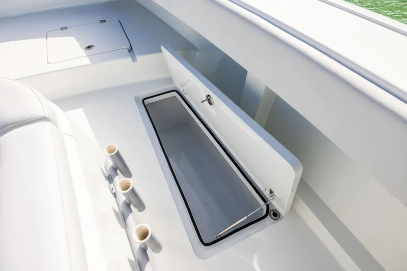  Yacht Photos Pics Open storage compartment on 2022 Freeman 42LR boat deck with rod holders.