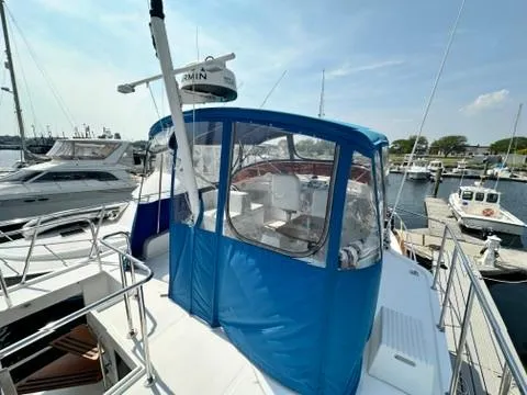 Brass Ring Yacht Photos Pics 2009 Marine Trader 36 Euro Sedan yacht with blue canopy docked at marina.