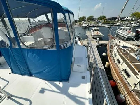 Brass Ring Yacht Photos Pics 2009 Marine Trader 36 Euro Sedan docked at a marina, featuring a blue canopy.