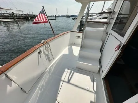 Brass Ring Yacht Photos Pics 2009 Marine Trader 36 Euro Sedan boat deck with American flag, docked at marina.