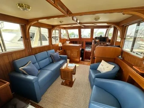 Brass Ring Yacht Photos Pics Interior of 2009 Marine Trader 36 Euro Sedan with blue seating and wooden accents.