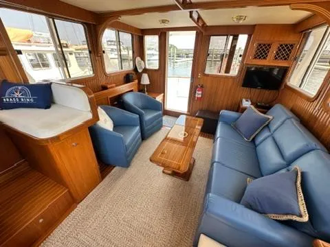 Brass Ring Yacht Photos Pics Interior of 2009 Marine Trader 36 Euro Sedan with blue seating and wooden accents.