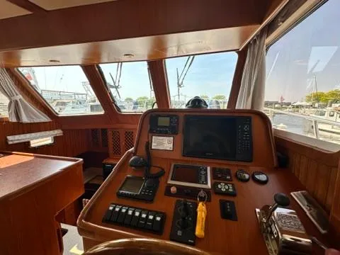 Brass Ring Yacht Photos Pics 2009 Marine Trader 36 Euro Sedan helm with navigation equipment and marina view.