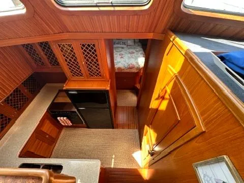 Brass Ring Yacht Photos Pics Interior of 2009 Marine Trader 36 Euro Sedan with wood finish and compact kitchen.