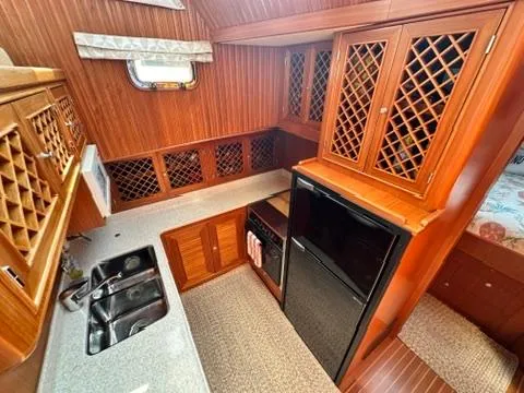 Brass Ring Yacht Photos Pics 2009 Marine Trader 36 Euro Sedan galley with wood cabinetry and modern appliances.
