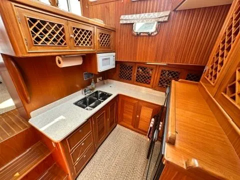 Brass Ring Yacht Photos Pics Luxurious 2009 Marine Trader 36 Euro Sedan yacht kitchen with wood cabinetry and modern appliances.