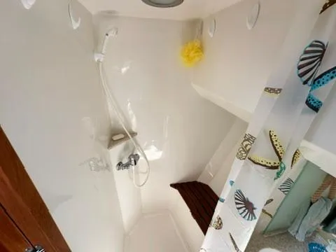 Brass Ring Yacht Photos Pics Shower area in 2009 Marine Trader 36 Euro Sedan with nautical-themed curtain.