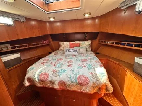 Brass Ring Yacht Photos Pics Cozy cabin interior of 2009 Marine Trader 36 Euro Sedan with nautical-themed bedding.