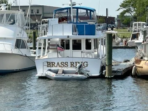 Brass Ring Yacht Photos Pics Marine Trader 36 Euro Sedan 2009 docked with dinghy, displaying "BRASS RING" name.
