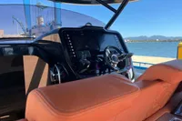 2023 SACS Strider 15 FB yacht cockpit with modern steering and controls, docked by the water.