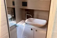 Modern bathroom interior on 2023 SACS Strider 15 FB yacht, featuring sleek sink and wood accents.