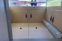 Interior cabin of 2023 SACS Strider 15 FB with wooden storage compartments.