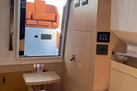 2023 SACS Strider 15 FB interior with modern wood finish and orange seating.