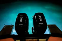 Twin Mercury 600 engines on 2023 SACS Strider 15 FB, illuminated at night.