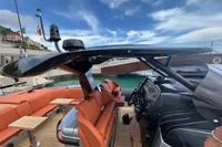 2023 SACS Strider 15 FB luxury yacht with orange seating and sleek black helm.