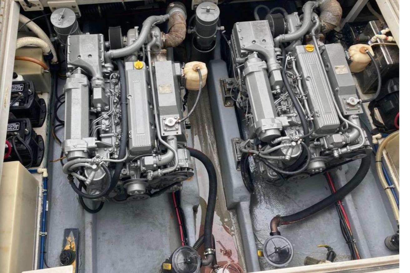 Twin engines in a 1997 Stamas 310 Express boat, showcasing detailed mechanical components.