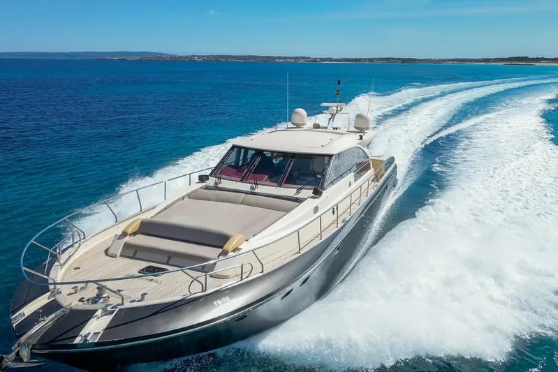 Vintage Yacht Photos Pics Luxurious 2006 Guy Couach 2100 yacht cruising on clear blue waters.