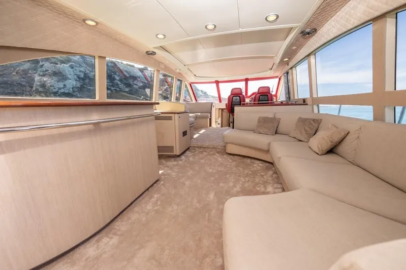 Vintage Yacht Photos Pics Luxurious interior of 2006 Guy Couach 2100 yacht with plush seating and panoramic windows.