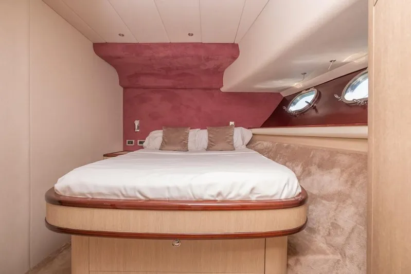 Vintage Yacht Photos Pics Luxurious bedroom interior of 2006 Guy Couach 2100 yacht with elegant design and porthole windows.
