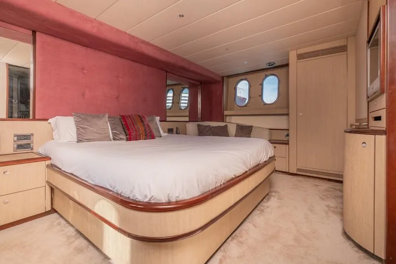 Vintage Yacht Photos Pics Luxurious bedroom interior on 2006 Guy Couach 2100 yacht with plush bedding and elegant decor.