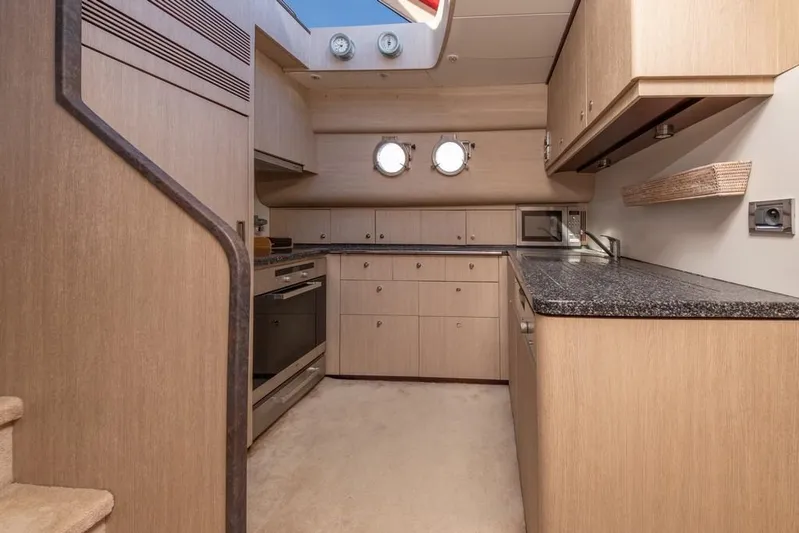 Vintage Yacht Photos Pics Luxurious kitchen interior of 2006 Guy Couach 2100 yacht with modern appliances.