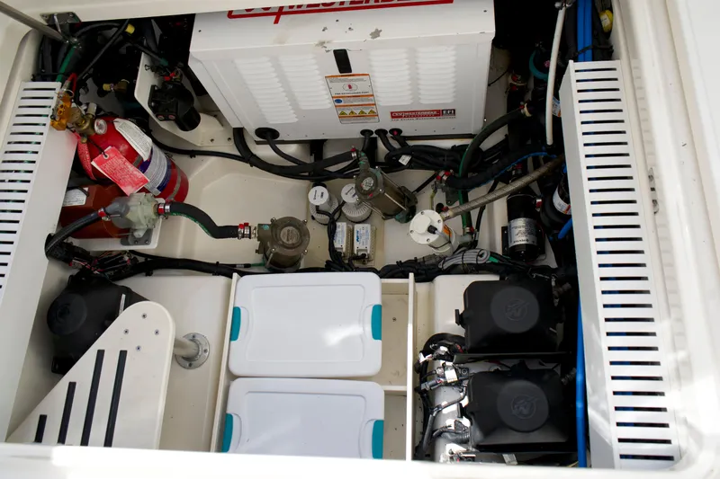 Yacht Kings Yacht Photos Pics Engine compartment of a 2020 Boston Whaler 350 Realm, showcasing mechanical components and storage.