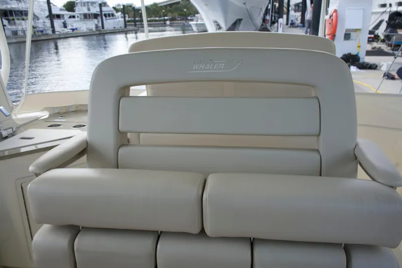 Yacht Kings Yacht Photos Pics 2020 Boston Whaler 350 Realm boat seat, beige leather, docked marina background.