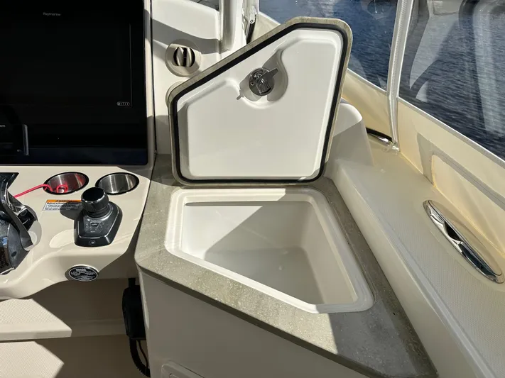 Yacht Kings Yacht Photos Pics 2020 Boston Whaler 350 Realm boat interior with open storage compartment and control panel.