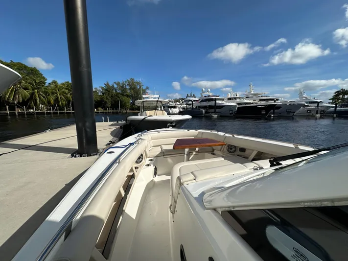 Yacht Kings Yacht Photos Pics 2020 Boston Whaler 350 Realm docked at marina with yachts in background.