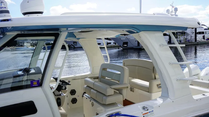 Yacht Kings Yacht Photos Pics 2020 Boston Whaler 350 Realm boat interior with seating and helm, docked at marina.