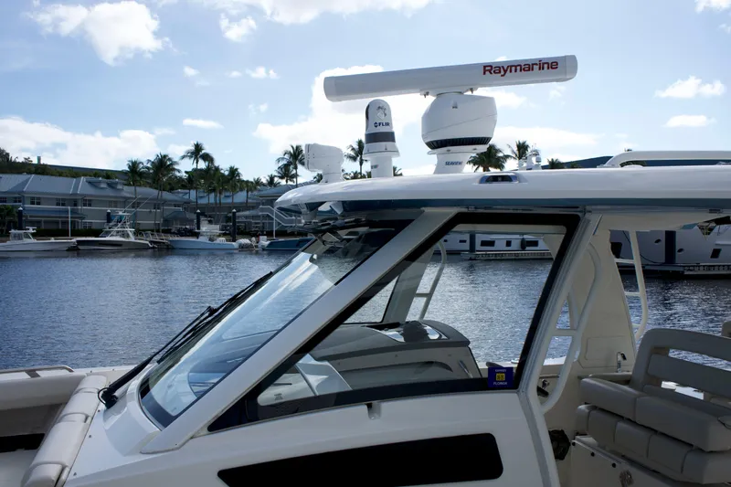 Yacht Kings Yacht Photos Pics 2020 Boston Whaler 350 Realm boat docked, featuring Raymarine equipment, with a scenic marina backdrop.