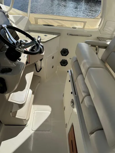Yacht Kings Yacht Photos Pics 2020 Boston Whaler 350 Realm interior with steering wheel and seating, showcasing luxury design.