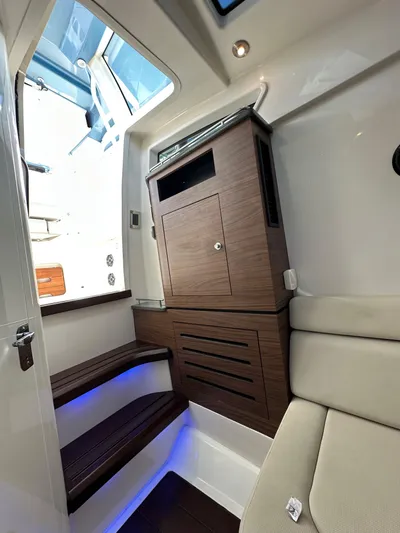 Yacht Kings Yacht Photos Pics Interior of 2020 Boston Whaler 350 Realm with wooden cabinetry and cushioned seating.