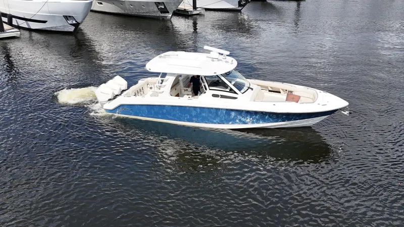 Yacht Kings Yacht Photos Pics 2020 Boston Whaler 350 Realm cruising on calm waters near docked boats.